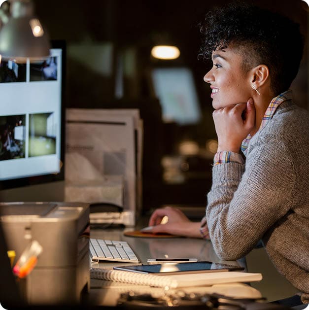 Graphic designers working late at computer in office at night