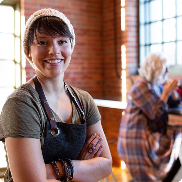 Portrait smiling barista in coffee shop